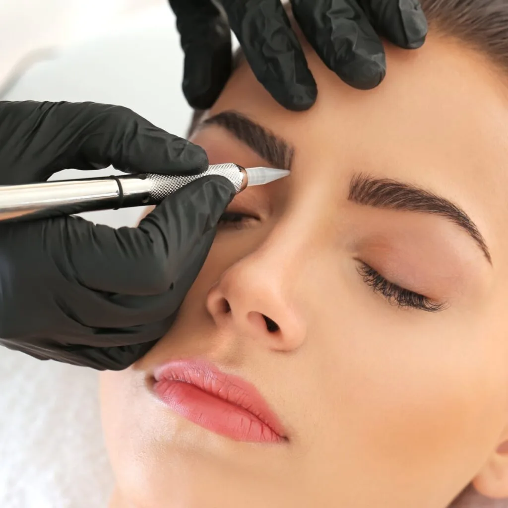 Eyebrow cosmetic tattoo procedure in progress